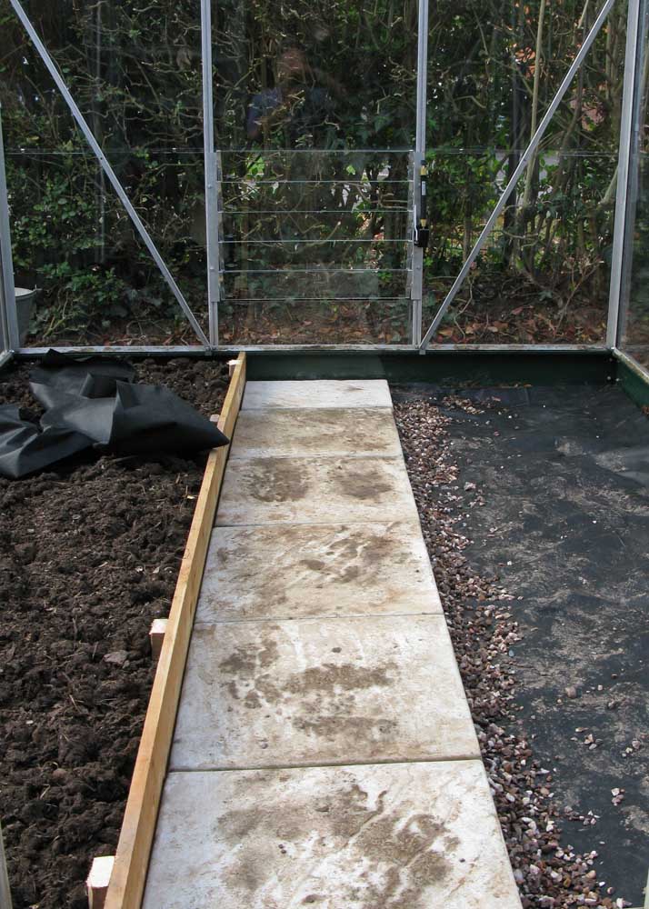 Raised bed held in by gravel board and some left over weed suppressing membrain under the gravel